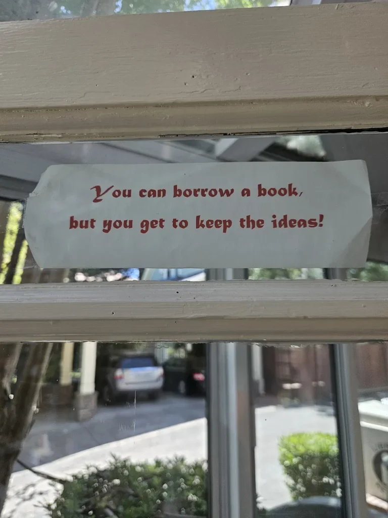 A sign taped to a door at the Ella K. McClatchy Library reading, "You can borrow a book, but you get to keep the ideas.